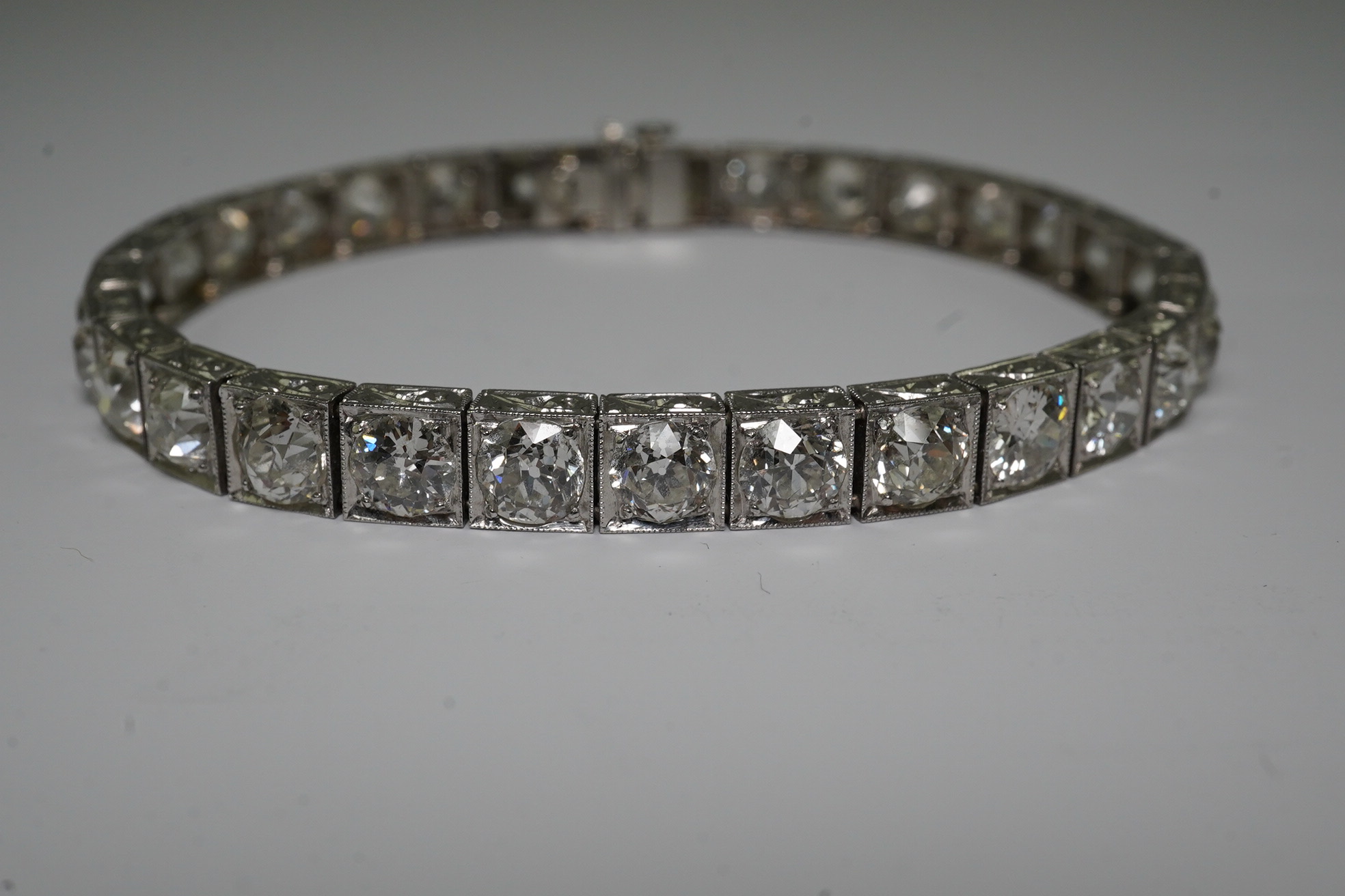 A platinum and thirty one stone round cut diamond set line bracelet